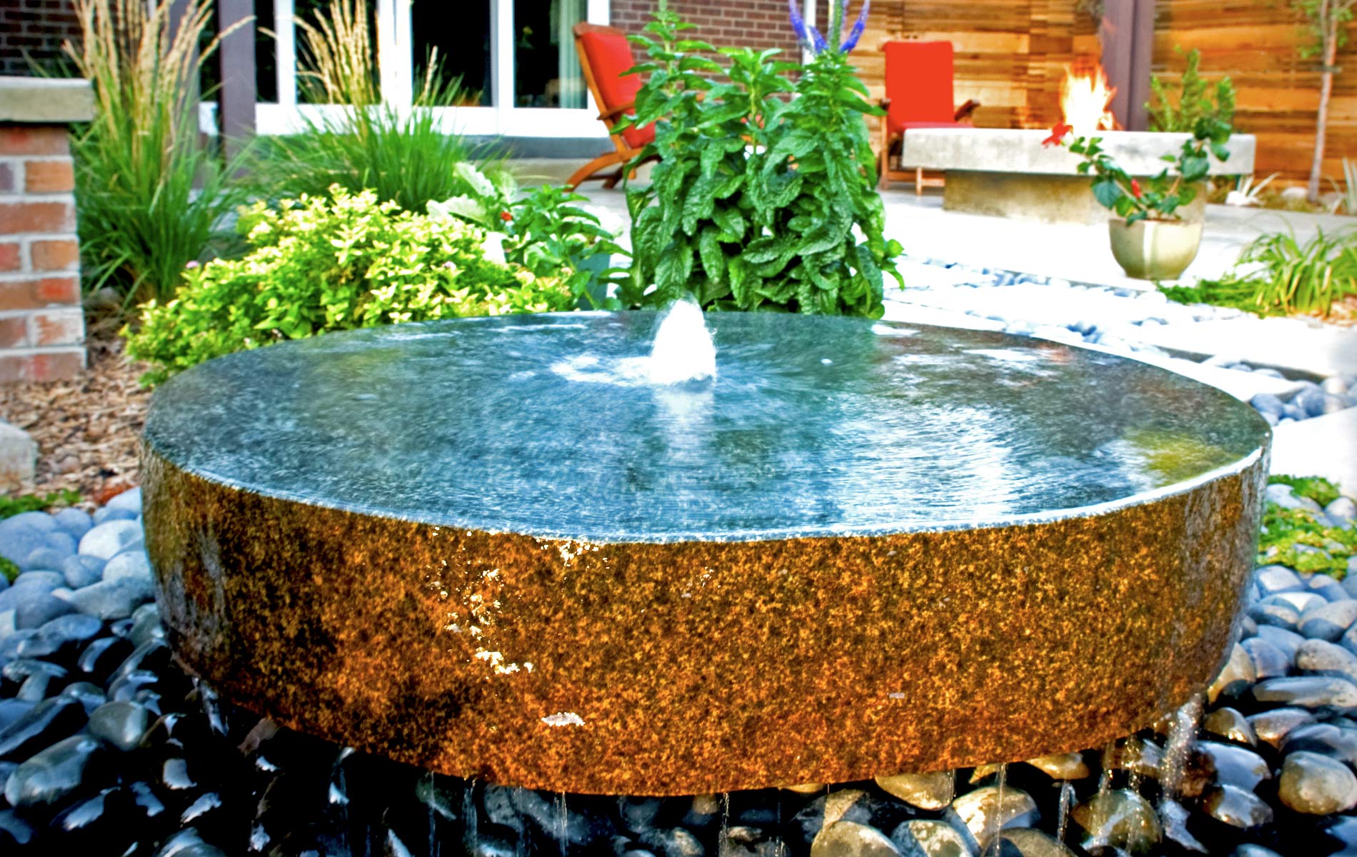 Milled basalt water fountain in Award Winning Outdoor Room Mile High Landscaping in Denver
