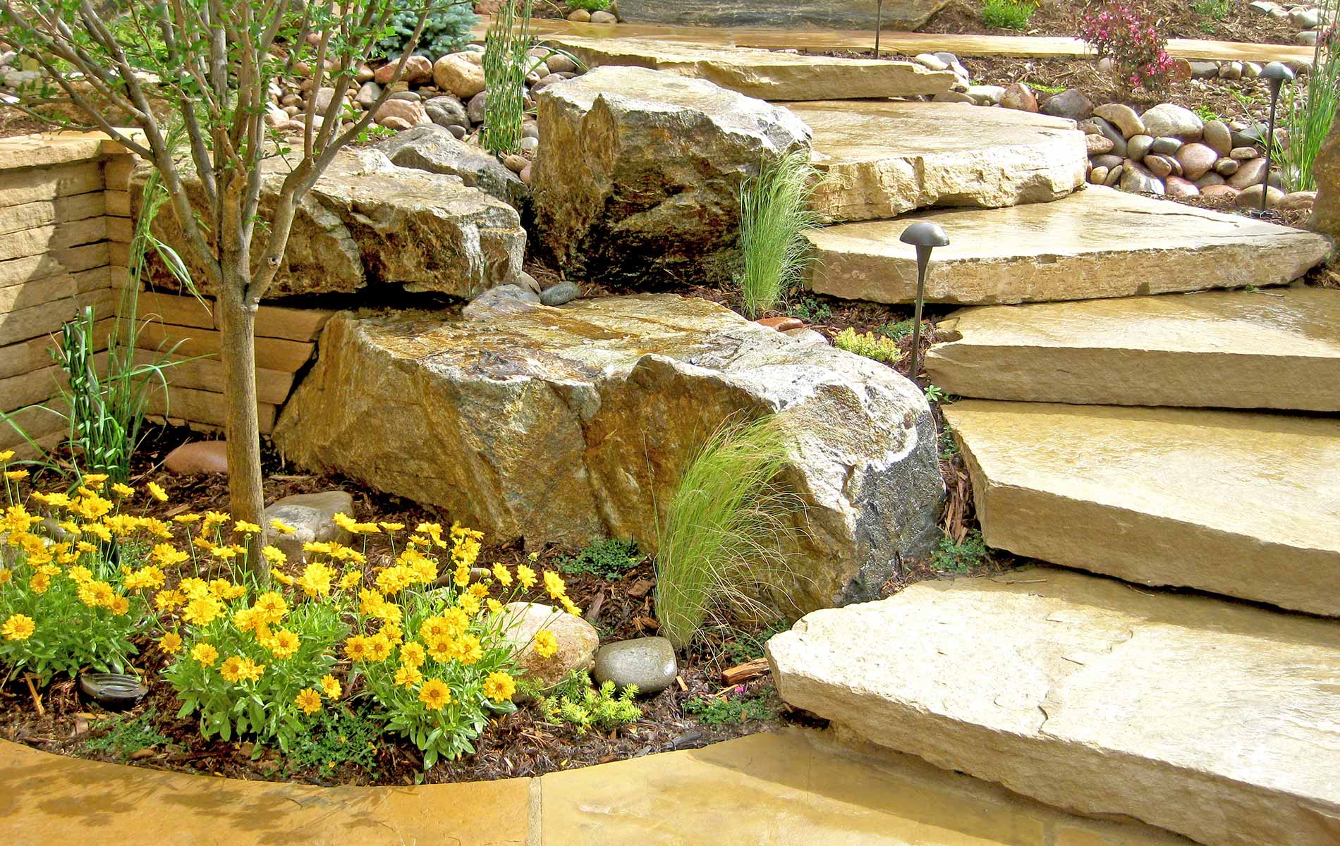 Natural stone stairs and plantings in Rustic Outdoor Living in Arvada Mile High Landscaping in Denver