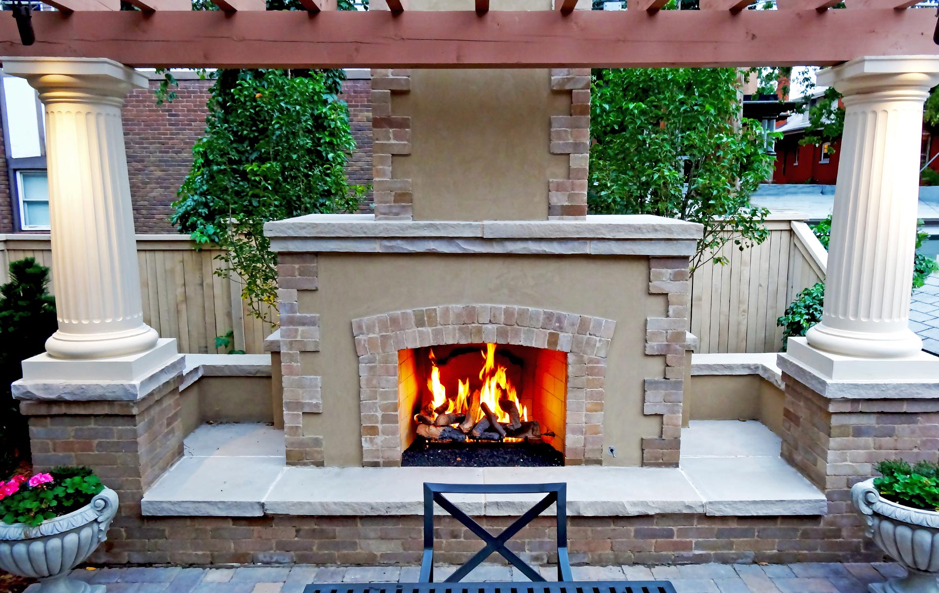 Formal Outdoor Fire Place with Brick and Stone and arbor in Historical House Courtyard Landscaped with Grand Architecture Mile High Landscaping in Denver