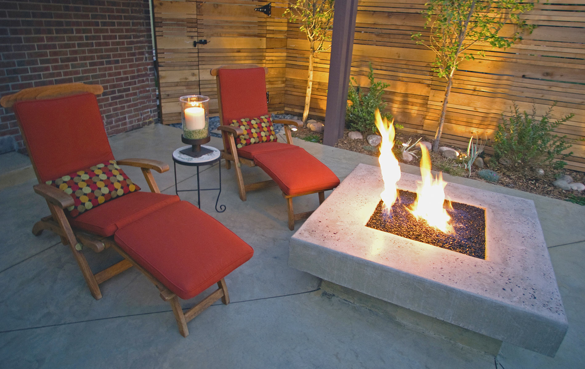 Glass topped firepit and pavers in Award Winning Outdoor Room Mile High Landscaping in Denver