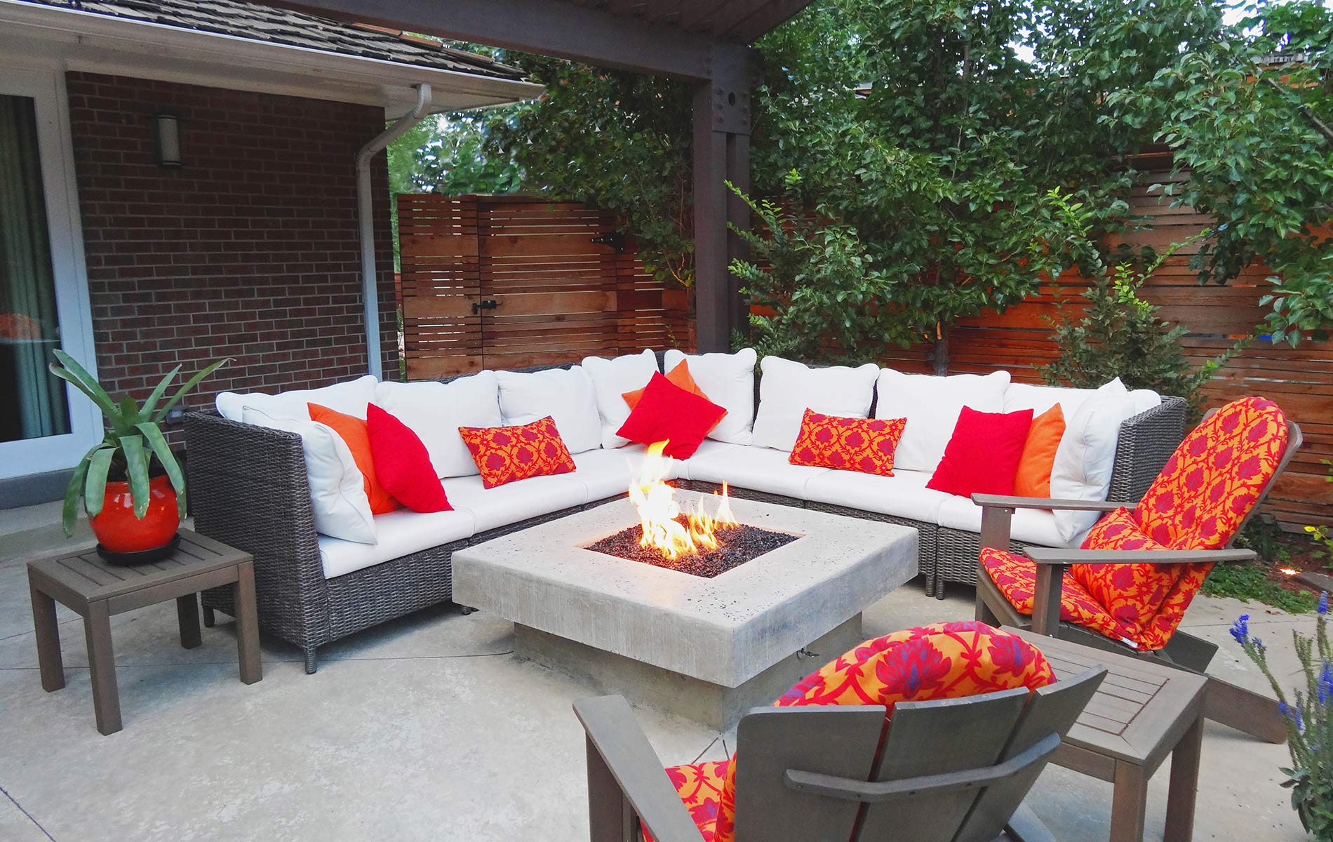 Sparkling glass topped firepit and sitting area in Award Winning Outdoor Room Mile High Landscaping in Denver