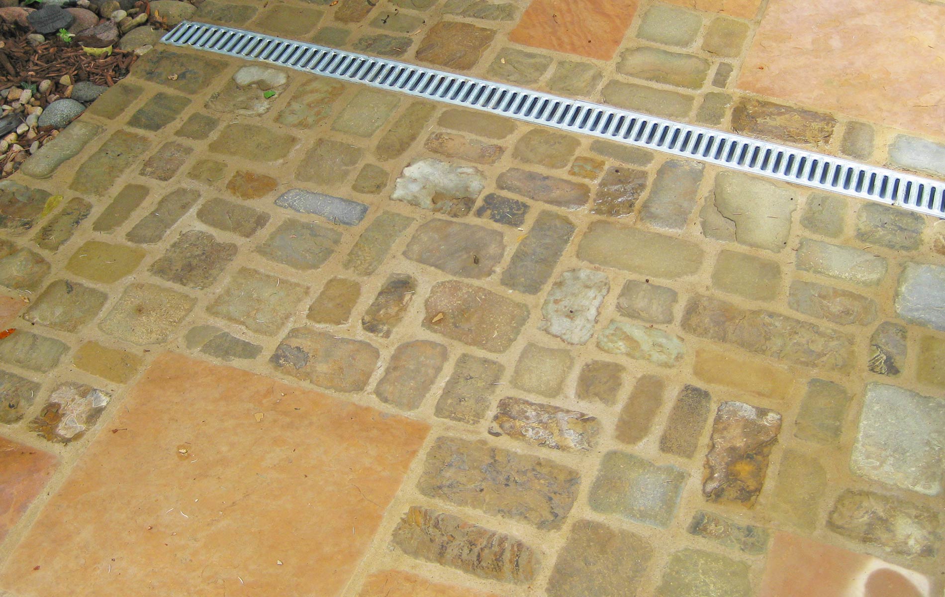 A unique variation in patio material accents surface drain